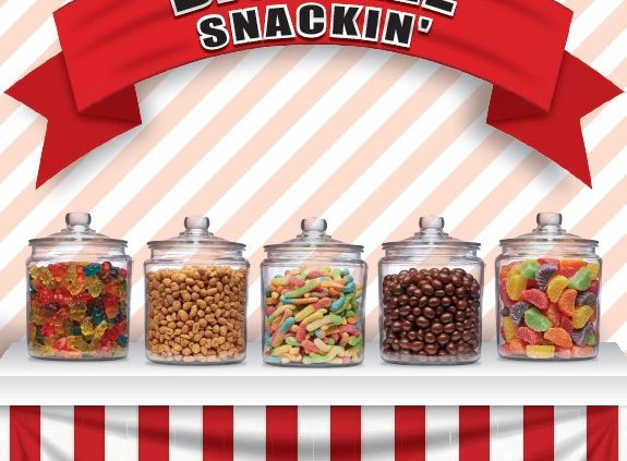 Candy jars under red striped awning.